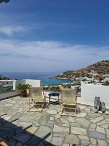 a patio with chairs and a view of the ocean at Kini Bay in Kini