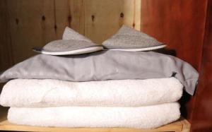 a stack of towels with a hat on top of them at Atié Haven in Lira