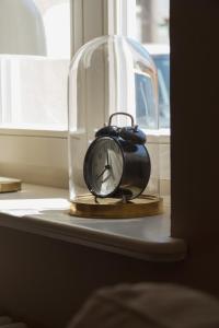 a clock sitting under a glass dome on a table at JETHON Appartement am Wasserturm 2 in Nienburg