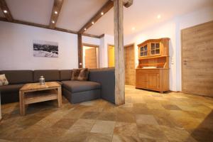 a living room with a couch and a table at Appartementhaus Brunnenhof in Wagrain