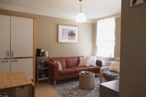 a living room with a couch and a table at JETHON Appartement am Wasserturm 2 in Nienburg