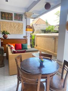 a living room with a table and a couch at Dewa Bungalows, A Balinese House and Art Gallery in Ubud