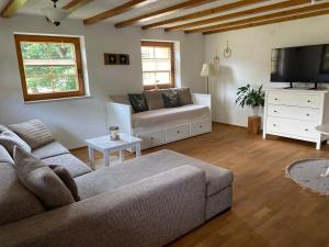 a living room with a couch and a tv at Haus Dekostüble in Münstertal