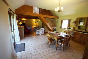 a kitchen and dining room with a table and chairs at Y Stablau - The Stables in St. Davids