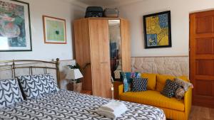 a bedroom with a bed and a couch at Studio with private pool in Villefranche-sur-Mer +8 photos