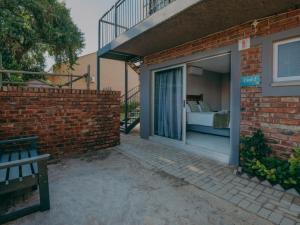 a brick building with a window with a bed in it at Cosy - Best Rest Potch in Potchefstroom