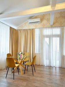 a dining room with a table and chairs at Hotel Plazma in Lviv