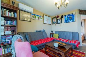 a living room with two couches and a coffee table at Nature Oasis Kravari - Private Pool & Jacuzzi in Stegvaši +18 photos