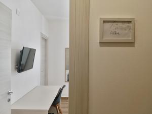 a door to a room with a table and a tv at La Principessa Nera B&B in Ostra