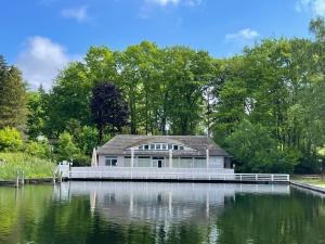 a house sitting on top of a body of water at Siblu Prϋβsee in Güster