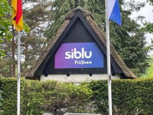 a sign on the side of a building with flags at Siblu Prϋβsee in Güster