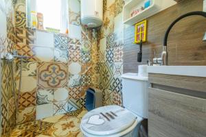 a bathroom with a toilet and a sink at Nature Oasis Kravari - Private Pool & Jacuzzi in Stegvaši