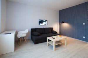 ein Wohnzimmer mit einem Sofa und einem Tisch in der Unterkunft Haas Apartments in Brünn