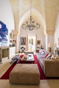 a living room with a large couch and a chandelier at Palazzo Saetta in Nardò
