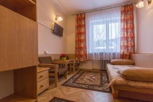 a living room with a couch and a window at Pensjonat Adria in Zakopane