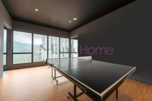 a ping pong table in a room with a home sign at Antharas 1 Premier Suites Genting Highlands in Genting Highlands