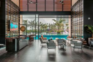 a lobby with a pool and tables and chairs at Antharas 1 Premier Suites Genting Highlands in Genting Highlands +19 photos