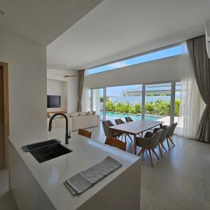 a kitchen and dining room with a view of the ocean at Horizon Villas Samui in Choeng Mon Beach