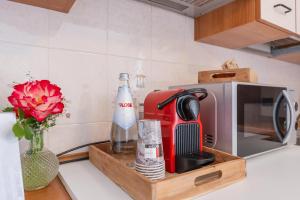 a kitchen counter with a bottle of milk and a microwave at Maranello Suite in Maranello