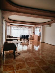 a large room with tables and chairs in it at Vila njoy by the sea in Eforie Sud