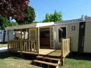 a screened in porch on a tiny house at Camping Paradis Aloé in Médis