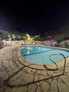 a swimming pool at night in a resort at Bluehibiscus in Saint-François +16 photos