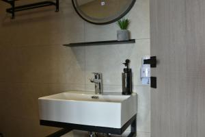 a white sink in a bathroom with a mirror at theaSee Sea & Mountain View in Nea Irakleia +59 photos