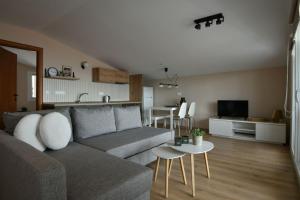 a living room with a couch and a table at theaSee Sea & Mountain View in Nea Irakleia