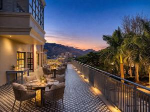 a balcony with tables and chairs on a building at Devi Palace - Monsoon Palace View Resort, Udaipur in Udaipur
