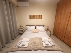a bedroom with a large bed in a room at ALIO Seaside Maisonette, Steps from Diakopto Beach in Diakopto