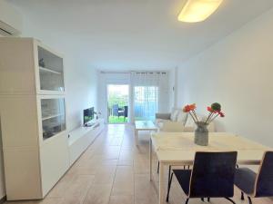 a living room with a table and a couch at HomeHolidaysRentals Lorraine - Costa Barcelona in Malgrat de Mar
