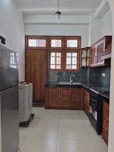 a kitchen with wooden cabinets and a sink at Holiday Inn in Colombo