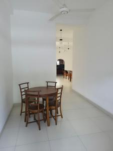 a dining room with a wooden table and chairs at Holiday Inn in Colombo