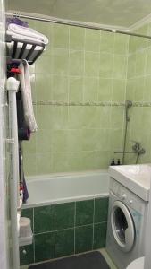 a bathroom with a washing machine and a sink at Квартира 1 линия in Balqash +7 photos