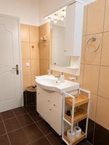 a bathroom with a white sink and a mirror at ALIO Seaside Maisonette, Steps from Diakopto Beach in Diakopto +45 photos