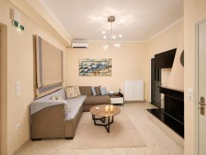 a living room with a couch and a table at ALIO Seaside Maisonette, Steps from Diakopto Beach in Diakopto