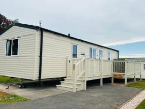a white trailer with a staircase and a house at Bang Tidy 261 - Cabin - Wifi - Pool - Sleep 6 in Paignton