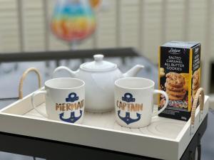 a tray with two coffee mugs and a box of cereal at Bang Tidy 261 - Cabin - Wifi - Pool - Sleep 6 in Paignton