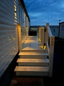 a stairway with lights on the side of a building at Bang Tidy 261 - Cabin - Wifi - Pool - Sleep 6 in Paignton