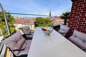 a bowl on a white table on a balcony at Historical Luxury Homes - Exclusive Selection in Freiburg im Breisgau