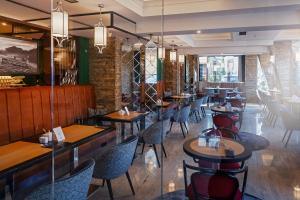 a restaurant with tables and chairs in a room at Rysy Boutique Hotel in Zakopane