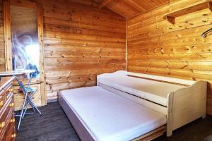 a bedroom with a bed in a wooden room at Ferienholzhaus Sternchen mit Terrasse in Zinnowitz