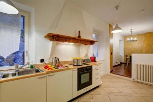 a kitchen with a sink and a stove top oven at Palazzo Gritti in Morcote