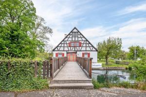 a house with a wooden bridge in front of a building at Oberling in Herbrechtingen