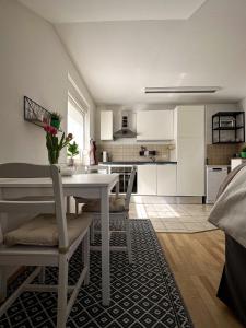 a kitchen and dining room with a white table and chairs at Gemütlich unterm Dach in Baunatal