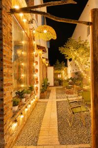 a patio with lights on the side of a building at YARA - Stay & Coffee in Mỹ Ðuc +18 photos
