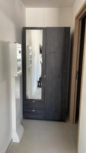 a wooden door with a mirror in a room at Studio cosy avec terrasse in Montpellier