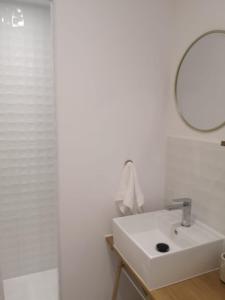 a white bathroom with a sink and a mirror at Domaine des Bichettes in Mareuil-sur-Lay +15 photos