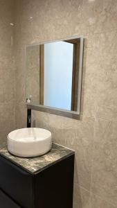 a bathroom with a sink and a mirror on a counter at Studio cosy avec terrasse in Montpellier
