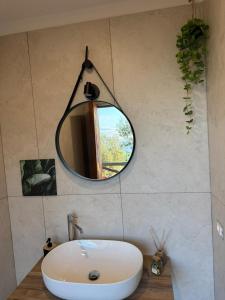 a bathroom with a sink and a mirror on the wall at Habitat Eco Farm in Sorrento +66 photos